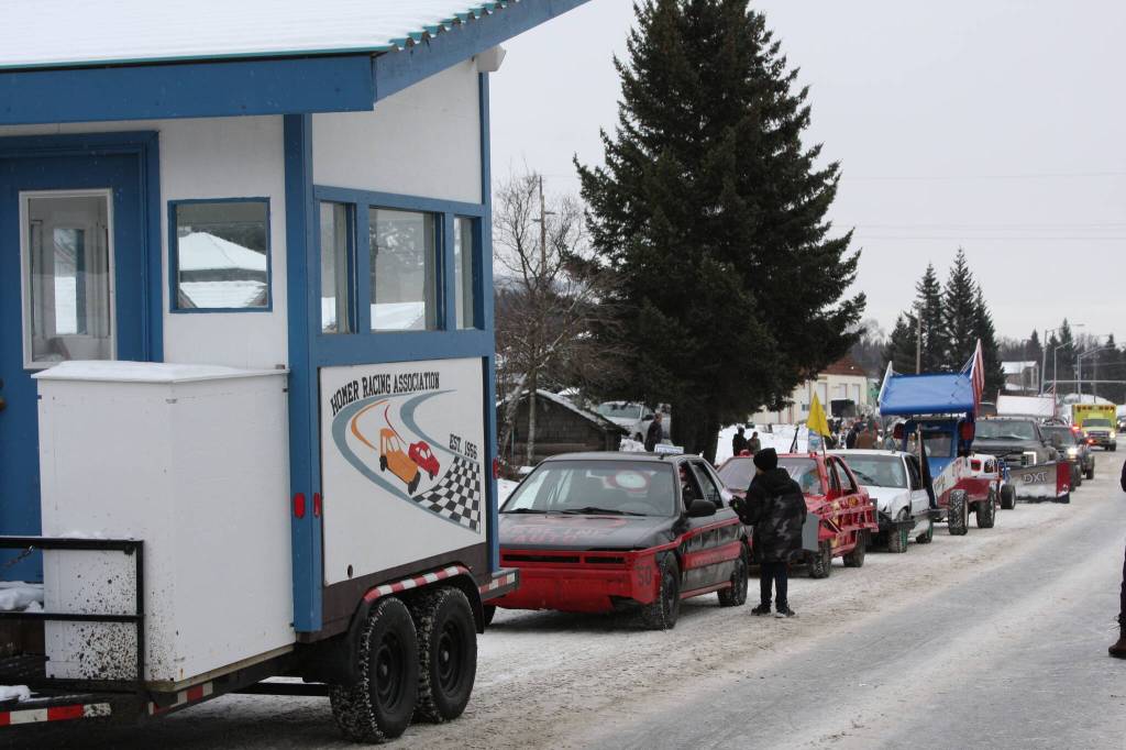 The Homer Racing Association drives down Pioneer Avenue in the 69th annual Winter Carnival Parade on Saturday, Feb. 11, 2023 in Homer, Alaska. Photo by Delcenia Cosman