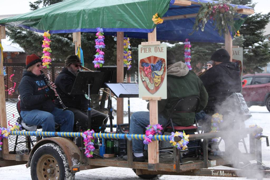 A quartet provides musical accompaniment on the Pier One Theatre float in the 69th Annual Winter Carnival Parade on Saturday, Feb. 11, 2023 in Homer, Alaska. Photo by Delcenia Cosman