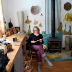 Willow Q. Jones winds twine on a foot brake to then use to tie a broom, in her home studio in Homer, February 2023. (Photo by Anore Jones/courtesy)