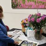 Colleen James looks through old photos of her 30 plus years of contributions to South Peninsula Hospital on Monday Feb. 20, 2023. Photo contributed by Derotha Ferraro.