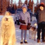 The Fenger children (Peter, at left, behind the dog, Heidi and Eric) pose near their home on the Homer bluff near the airport. Their dogs were Hartford (L) and Flojo. (Photo courtesy of the Fenger Family Collection)