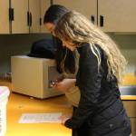 Seanna Swanson (front) and Kelsi Curren (rear) review a recipe for pretzels during a foods class at Kenai Central High School on Wednesday, Feb. 22, 2023 in Kenai, Alaska. (Ashlyn OHara/Peninsula Clarion)