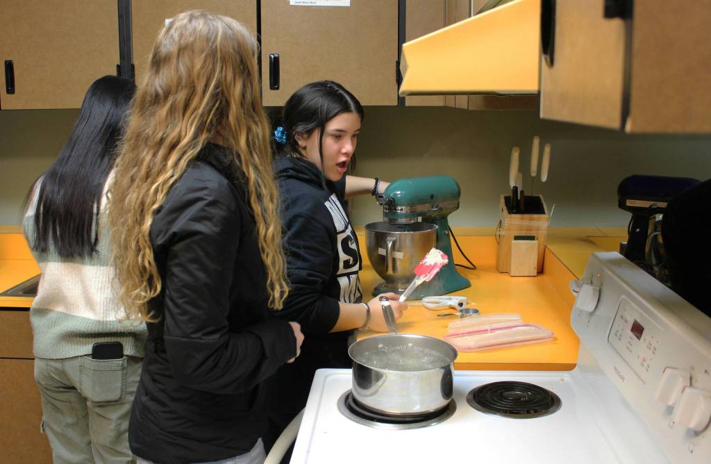 Maddie Cazares mixes pretzel dough during a foods class at Kenai Central High School on Wednesday, Feb. 22, 2023 in Kenai, Alaska. (Ashlyn OHara/Peninsula Clarion)