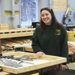 Kenai Central High School senior Jorgi Phillips stands next to a wooden box she made to transport metal art on Wednesday, Feb. 22, 2023 in Kenai, Alaska. (Ashlyn OHara/Peninsula Clarion)