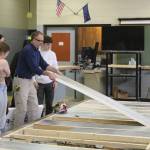 Construction teacher Tim Wight helps students adjust insulation during a class at Soldotna High School on Wednesday, Feb. 22, 2023 in Soldotna, Alaska. (Ashlyn OHara/Peninsula Clarion)
