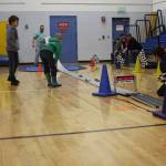 Pinewood derby contestants wait for their cars to cross the finish line in the Chapman School gym during the Snow Rondi on Saturday<ins>,</ins><ins> March 4</ins> in Anchor Point<ins>,</ins> <ins>Alaska</ins>. (Photo by Delcenia Cosman/Homer News)
