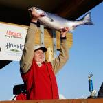 The 28th annual Homer Winter King Salmon Tournament winner Weston Marley holds up the 27.38-pound winter king salmon he caught on Sunday, April 10, 2022, in Kachemak Bay, Homer, Alaska. (Photo by Michael Armstrong/Homer News)