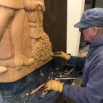 Art Koeninger works on the Loved & Lost memorial bench in the summer 2022 at a shop out East End Road. Photo by Christina Whiting/Homer News)