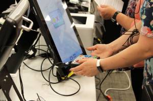 Rachel Nash tests voting equipment at the George A. Navarre Borough building on Thursday, Sept. 9, 2021, in Soldotna, Alaska. (Ashlyn OHara/Peninsula Clarion)