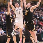 Ninilchiks Rowan Mahoney goes up for a shot against Tikigaqs Micah Kinneeveauk and Aqquilluk Hank in the Class 2A boys state championship Saturday, March 18, 2023, at the Alaska Airlines Center in Anchorage, Alaska. (Photo courtesy of Robin Moore)