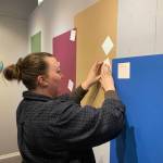 Tabitha Lindsay, visiting from Wisconsin, writes what bodily autonomy means to her during the exhibit at Homer Council on the Arts, March 16. (Photo by Christina Whiting/Homer News)