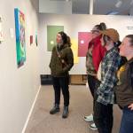 A group of young women visiting Homer take in the Bodily Autonomy exhibit at Homer Council on the Arts on March 15. (Photo by Christina Whiting/Homer News)