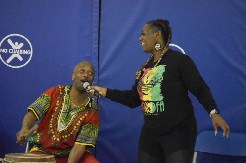 The members of Sankofa Dance Theater Alaska sing for a crowd of students during an opening performance at Kaleidoscope School of Arts and Science in Kenai, Alaska on Monday, March 20, 2023. (Jake Dye/Peninsula Clarion)
