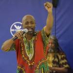 Johnnie Wright III sings for a crowd of students during an opening performance by Sankofa Dance Theater Alaska at Kaleidoscope School of Arts and Science in Kenai, Alaska on Monday, March 20, 2023. (Jake Dye/Peninsula Clarion)