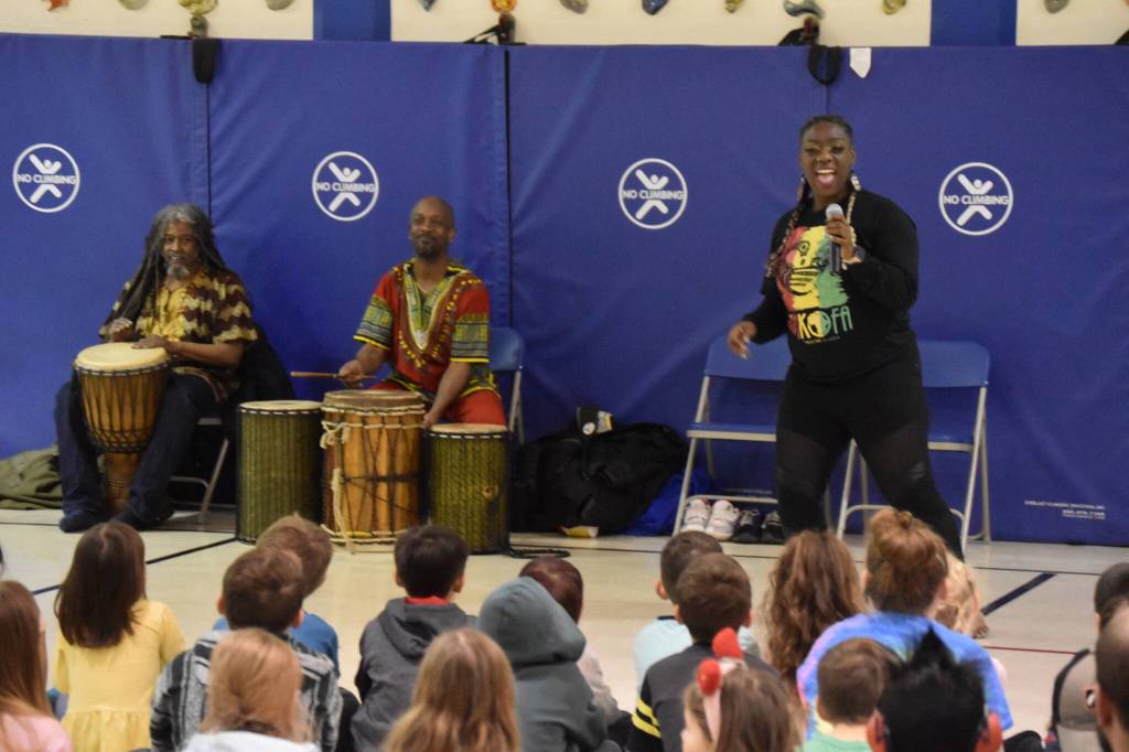The members of Sankofa Dance Theater Alaska perform for a crowd of students during an opening performance at Kaleidoscope School of Arts and Science in Kenai, Alaska on Monday, March 20, 2023. (Jake Dye/Peninsula Clarion)