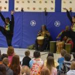 The members of Sankofa Dance Theater Alaska perform for a crowd of students during an opening performance at Kaleidoscope School of Arts and Science in Kenai, Alaska on Monday, March 20, 2023. (Jake Dye/Peninsula Clarion)