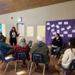A small group discusses common themes in the ongoing housing crisis during the community conversation on housing solutions in the greater Homer area at Christian Community Church on Saturday. Photo by Delcenia Cosman