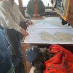 Photo by Emilie Springer/ Homer News
R/V Tiglax Captain John Faris shows students a chart of Kachemak Bay and Cook Inlet in the wheelhouse of the boat in the harbor in Homer on April 6.