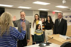 Peter Micciche (second from left) is sworn in as mayor of the Kenai Peninsula Borough on Monday, Feb. 27, 2023, in Soldotna, Alaska. (Ashlyn OHara/Peninsula Clarion)