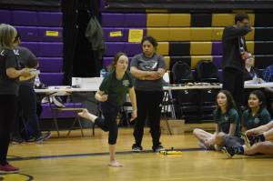 A Homer athlete competing in the senior division performs the Scissor Broad Jump during the Salamatof Tribe Traditional Native Games Invitational at Kenai Middle School in Kenai, Alaska, on Friday, April 14, 2023. (Jake Dye/Peninsula Clarion)