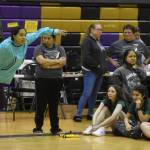 An athlete competing with the Salamatof Tribe leaps forward as she performs the Scissor Broad Jump during the Salamatof Tribe Traditional Native Games Invitational at Kenai Middle School in Kenai, Alaska, on Friday, April 14, 2023. (Jake Dye/Peninsula Clarion)