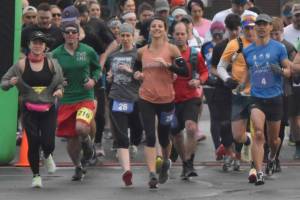 Marathon and half marathon runners begin the Kenai River Marathon on Sunday, Sept. 25, 2022, in Kenai, Alaska. At the front are women's marathon winner Amanda Cherok (28), men's half marathon winner Lee Frey (third from right), women's half marathon winner Kristin Davis (242) and men's marathon winner and new event record holder Lars Arneson (36).