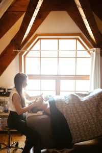 Dharmic Spruce owner Branden Elded performs a Get Glowing spa facial treatment on a customer in April <ins>2023 in Homer, Alaska</ins>.