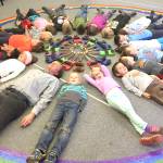 Daniel Perry show Paul Banks Preludes first-graders how to start with cardboard violins during the first year of the music program in the fall of 2016.