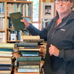 Photo by Christina Whiting
Andy Wills, owner of the Old Inlet Bookshop shows a book he received from his mothers bookshop collection on Monday, March 27.