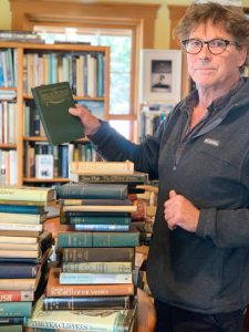 Photo by Christina Whiting
Andy Wills, owner of the Old Inlet Bookshop shows a book he received from his mothers bookshop collection on Monday, March 27.