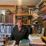 Owner Andy Wills sits behind the front counter of the Old Inlet Bookshop in Old Town Homer<ins>, Alaska</ins> on Tuesday, March 28<ins>, 2023</ins>. Photo by Christina Whiting