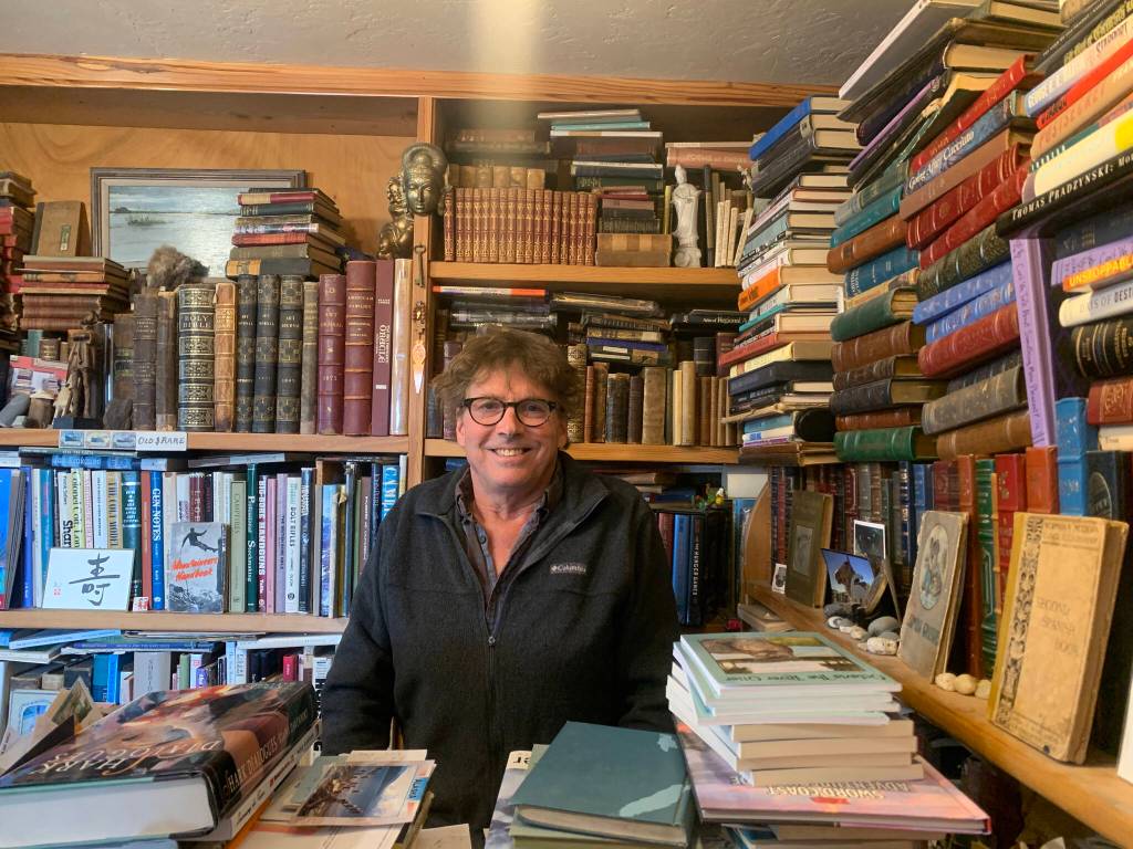 Owner Andy Wills sits behind the front counter of the Old Inlet Bookshop in Old Town Homer<ins>, Alaska</ins> on Tuesday, March 28<ins>, 2023</ins>. Photo by Christina Whiting
