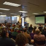 Cook Inletkeeper Science Director Sue Mauger speaks in front of a packed crowd during a panel discussion for the Kenai Peninsula College Showcase State of the Salmon on Wednesday, April 20, 2023, at KPC in Soldotna, Alaska. (Jake Dye/Peninsula Clarion)