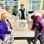 Community members gather April 26 at the Homer Public Library for a ceremony to celebrate the installation of the final aspect of the Loved & Lost Memorial Bench, an etched glass and bronze lotus lamp, envisioned by artist Brad Hughes and designed and created by Art Koeninger.( Photo by Christina Whiting/Homer News)