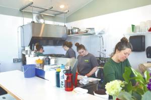 Photo by Delcenia Cosman
The Tickled Pear staff fill orders during their grand opening in their new permanent location on Friday, May 5,. Owner Ashley Steiner is pictured second from left.