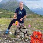 Kachemak Bay Running Club member Kathy Sarns-Irwin marks the trail in 2022 for the Race to Grace Ridge run held every summer in Homer, Alaska. Photo provided by Kachemak Bay Running Club