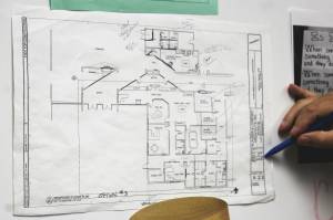 Kenai Middle School Principal Vaughn Dosko points out elements of a redesign plan for the front of the school on Wednesday, Sept. 21, 2022 in Kenai, Alaska. (Ashlyn OHara/Peninsula Clarion)