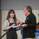 Kiernan Lapp, of Soldotna High School, is introduced by Merrill Sikorski at the Caring for the Kenai Awards Celebration held during a Joint Chamber Luncheon on Wednesday, May 3, 2023, at the Soldotna Regional Sports Complex in Soldotna, Alaska. (Jake Dye/Peninsula Clarion)