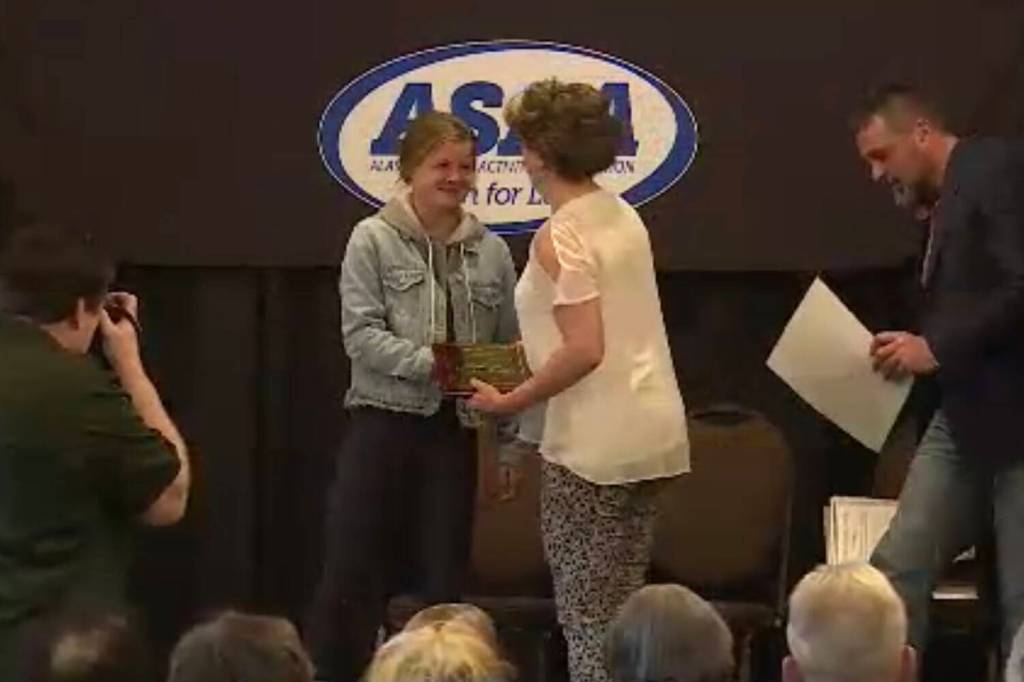 Allie Ostrander is presented her award by Stacia Rustad at the Alaska High School Hall of Fames Class of 2023 induction ceremony on Sunday, May 7, 2023, at The Lakefront Hotel in Anchorage, Alaska. (Screenshot)