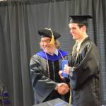 Kachemak Bay Campus director Dr. Reid Brewer (center) presents Jonathan Rozeboom (right) with his Associate of Arts diploma during the 2023 KBC Commencement on Wednesday, May 10, 2023 in Homer, Alaska. (Photo by Delcenia Cosman/Homer News)