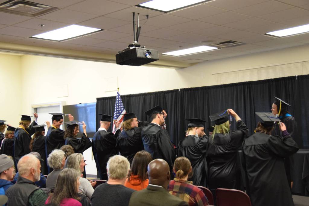 The 2023 graduates turn their tassels to the left as University of Alaska Anchorage Vice Chancellor Deanna Woodard confers the degrees during the 2023 KBC Commencement on Wednesday, May 10, 2023, in Homer, Alaska. (Photo by Delcenia Cosman/Homer News)