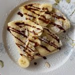 The simple yet versatile crepe can be served savory or sweet, such as this banana, powdered sugar and chocolate creation. (Photo by Tressa Dale/Peninsula Clarion)
