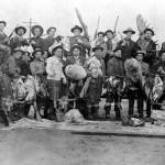 Photo #AMRC-b63-16-47 from the Marie Silverman Collection in the online Alaska Digital ArchivesLibrary & Archives of the Anchorage Museum of History & Art
A note in the lower left corner of this circa 1912 photo says German Doctor, and an arrow points to Dr. John Baughman, who is posing with the rest of the Seward Outing Club after a successful hunt.