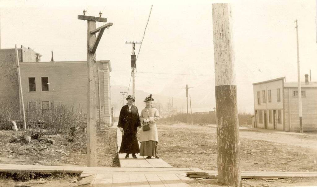 Photo #1.628 courtesy of the Seward Community Library Association
Dr. John Baughmans wife, Mina (left), poses in this circa 1905-10 photo with Mrs. E.E. Hale on a Seward city sidewalk near the Alaska Central Railroad and Sewards first school.