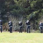 VFW Post 10221 post member Frances Richter (right) calls cadence as honor guard members Joe Keller, Brian Malneritch and Clyde Hixson fire a gun salute during a Memorial Day service held at the Anchor Point Kallman Cemetery on Monday, May 29, 2023 in Anchor Point, Alaska. (Delcenia Cosman/Homer News)