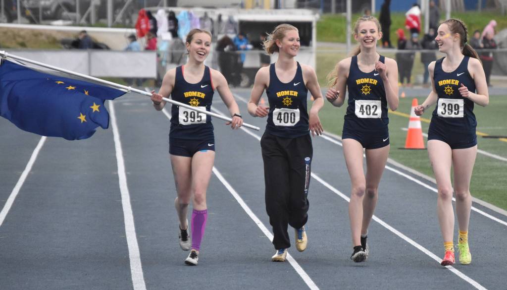 Homers Eryn Field, Gracie Miotke, Brightly Thoning and Beatrix McDonough celebrate winning the Division II 1,600-meter relay Saturday, May 27, 2023, at the state track and field meet at Palmer High School in Palmer, Alaska. (Photo by Jeff Helminiak/Peninsula Clarion)