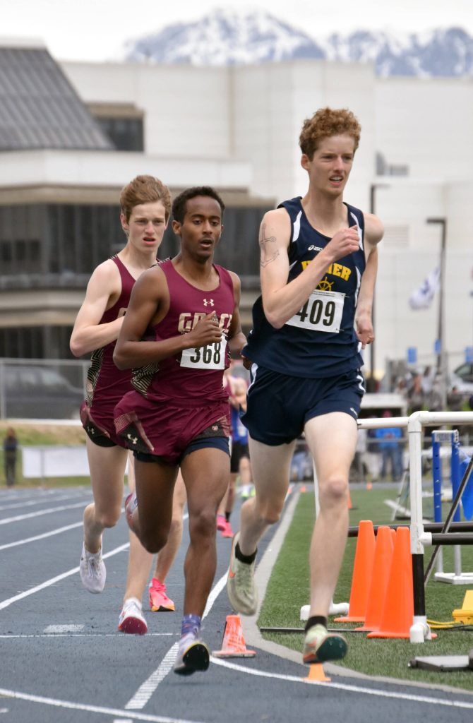 Homers Seamus McDonough is chased by Grace Christians David Sliwinski and Robbie Annett in the Division II 1,600-meter run Saturday, May 27, 2023, at the state track and field meet at Palmer High School in Palmer, Alaska. (Photo by Jeff Helminiak/Peninsula Clarion)