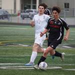 Soldotnas Gehret Medcoff and Juneau-Douglas Gabriel Cheng race for the ball during the Division II Soccer State Championship on Saturday, May 27, 2023, at West Anchorage High School in Anchorage, Alaska. (Jake Dye/Peninsula Clarion)