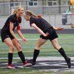 Kenai Centrals Calani Holmes and Rylie Sparks celebrate after Sparks scored their first goal of the game during the Division II Soccer State Championship on Saturday, May 27, 2023, at West Anchorage High School in Anchorage, Alaska. (Jake Dye/Peninsula Clarion)