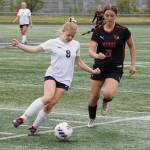 Soldotnas Keely Sundberg battles for the ball with Kenai Centrals Ella Yragui during the Division II Soccer State Championship on Saturday, May 27, 2023, at West Anchorage High School in Anchorage, Alaska. (Jake Dye/Peninsula Clarion)